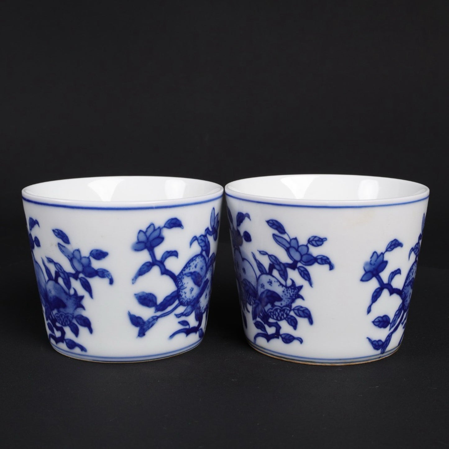 A pair of blue and white lucky, lucky, and longevity patterned cups