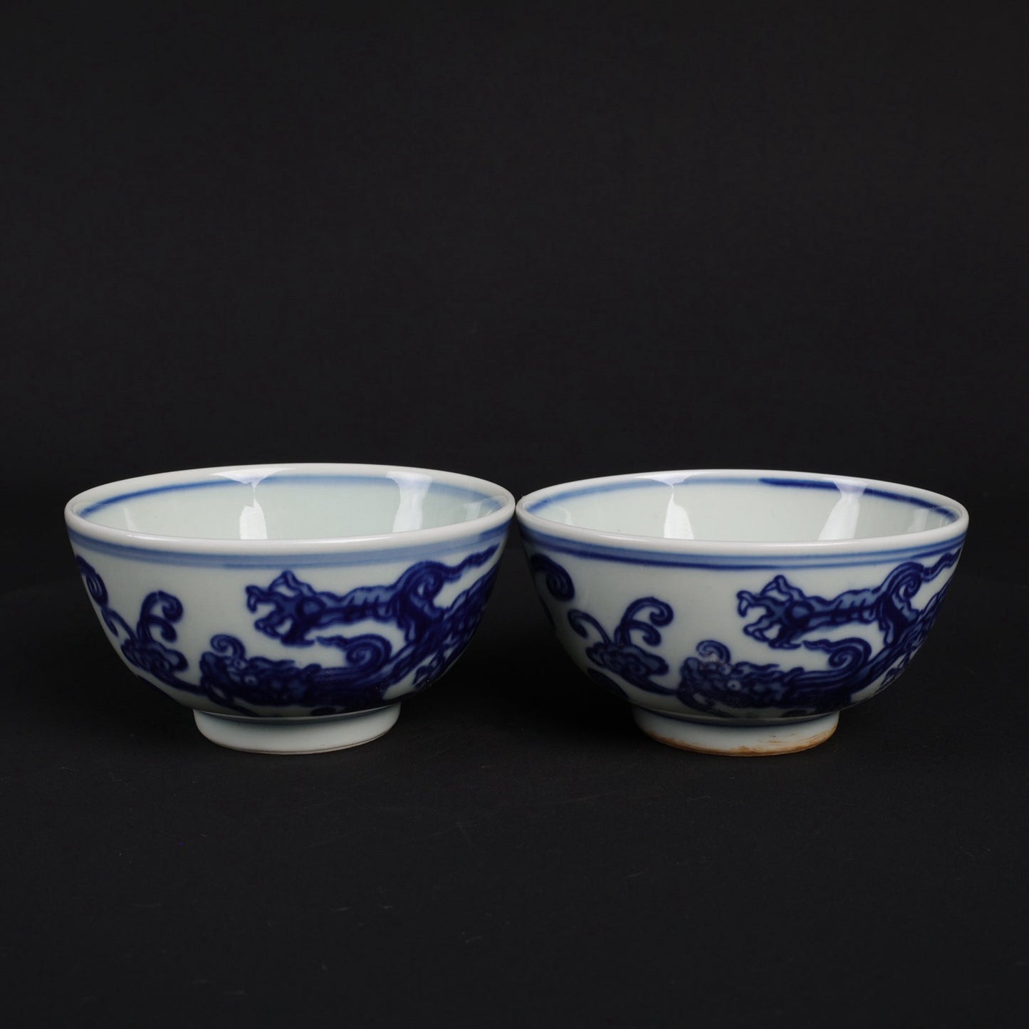 A pair of blue and white dragon patterned cups