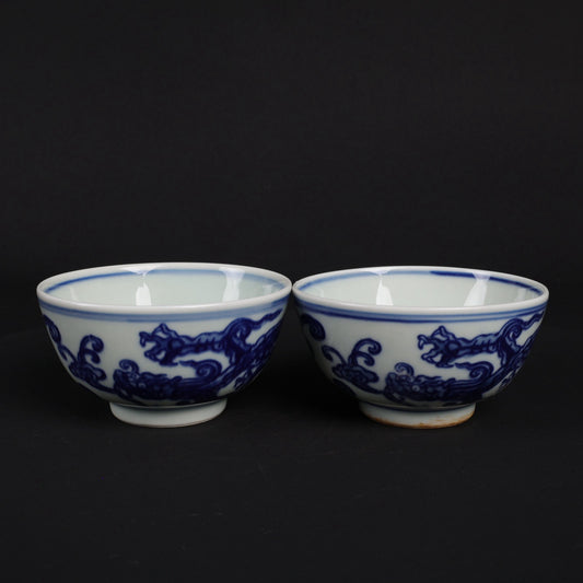 A pair of blue and white dragon patterned cups