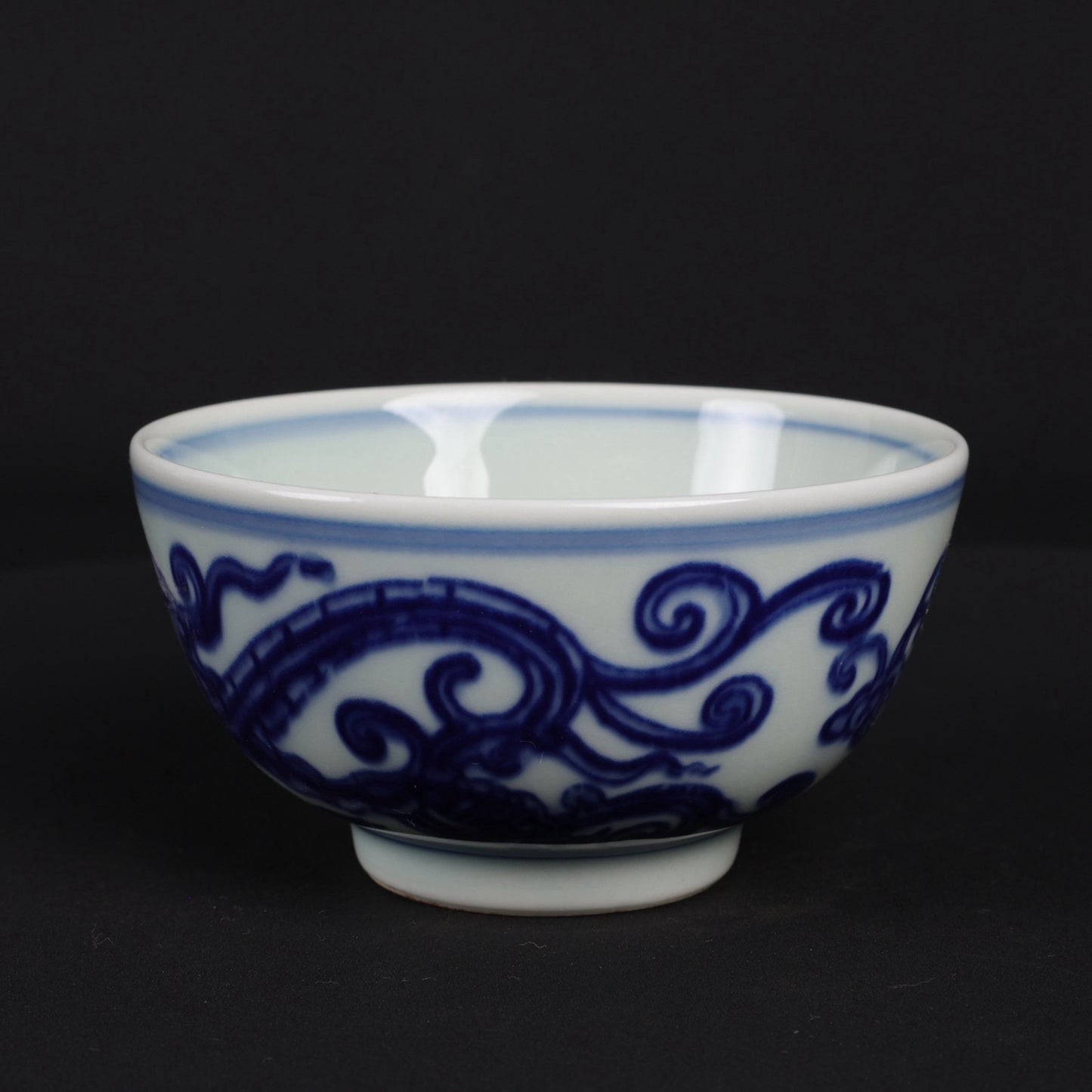 A pair of blue and white dragon patterned cups