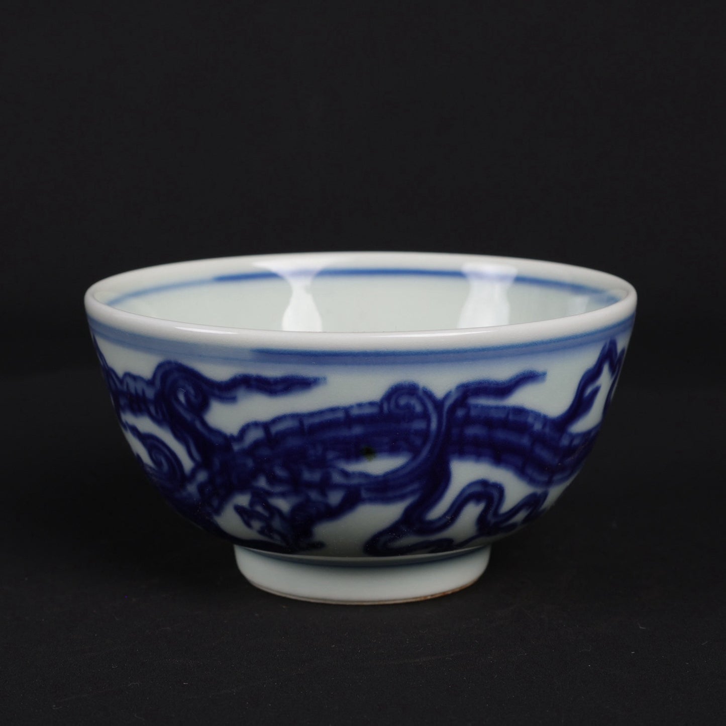 A pair of blue and white dragon patterned cups