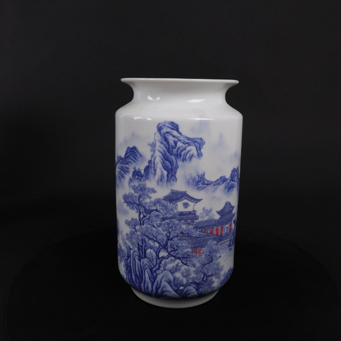 A pair of blue and white vases with mountain and water patterns