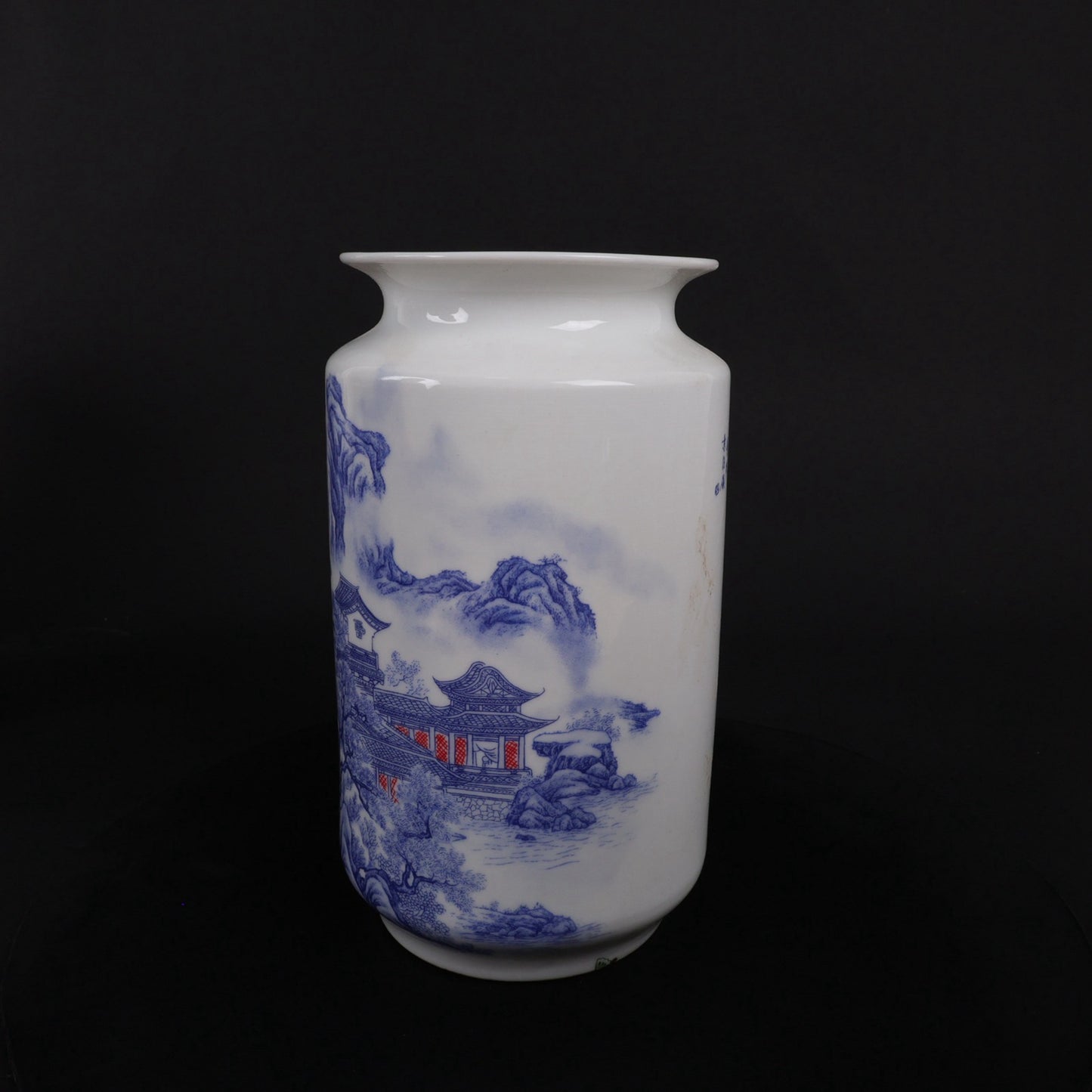 A pair of blue and white vases with mountain and water patterns