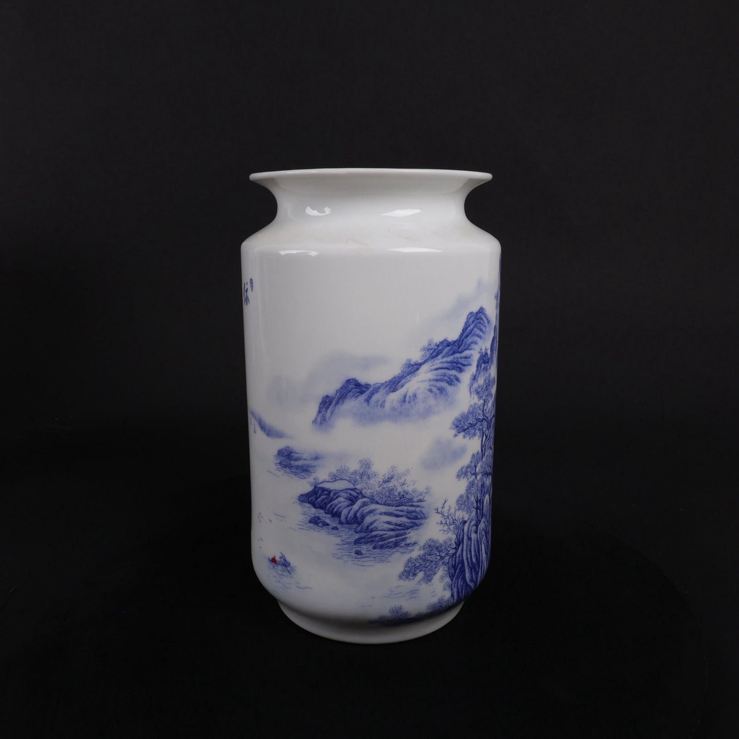 A pair of blue and white vases with mountain and water patterns