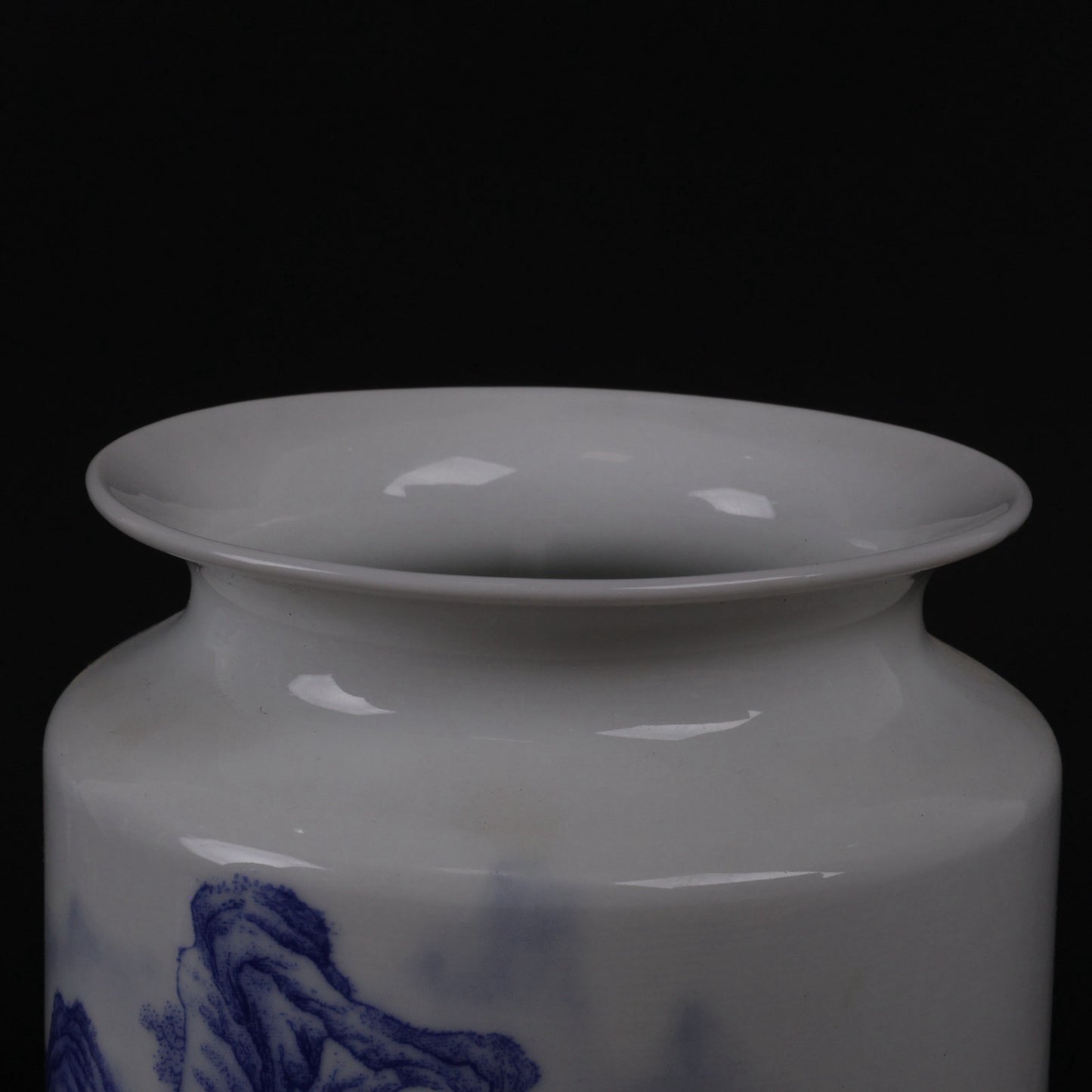 A pair of blue and white vases with mountain and water patterns