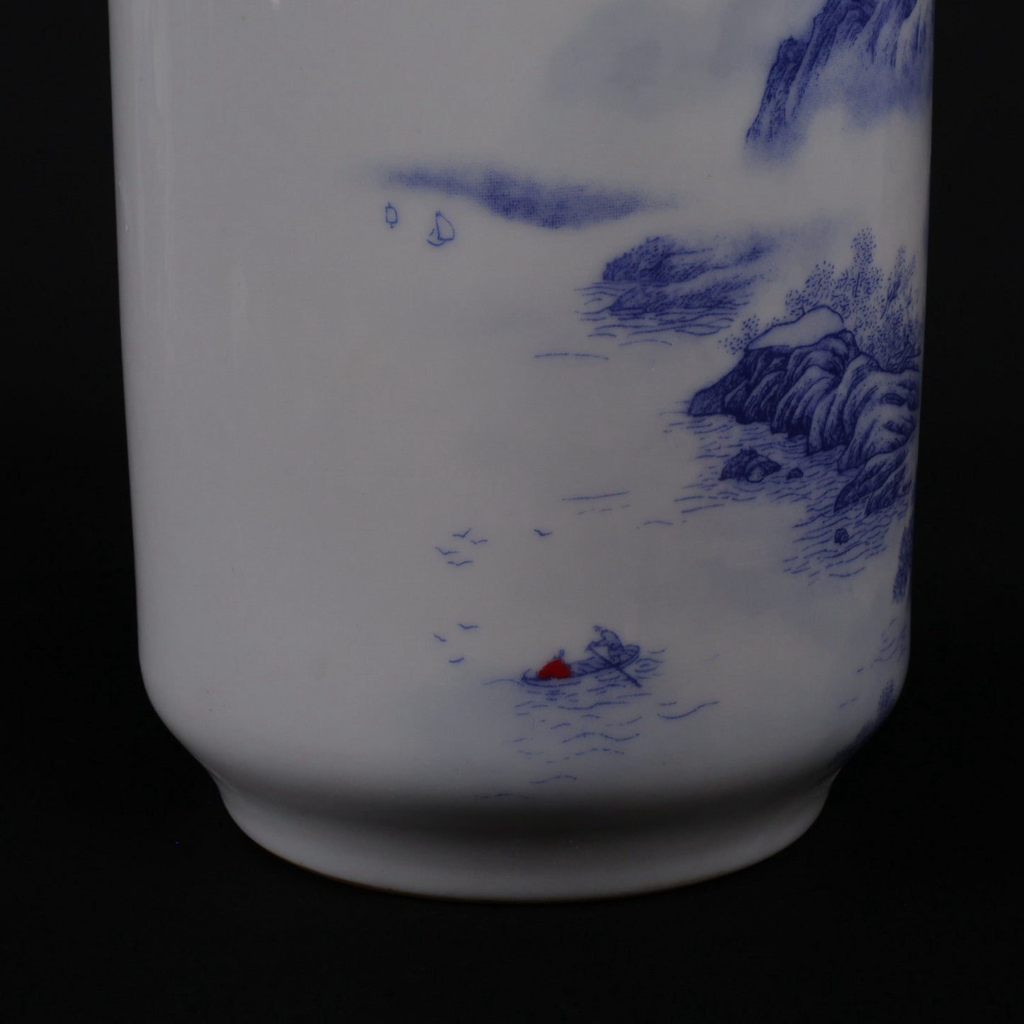 A pair of blue and white vases with mountain and water patterns