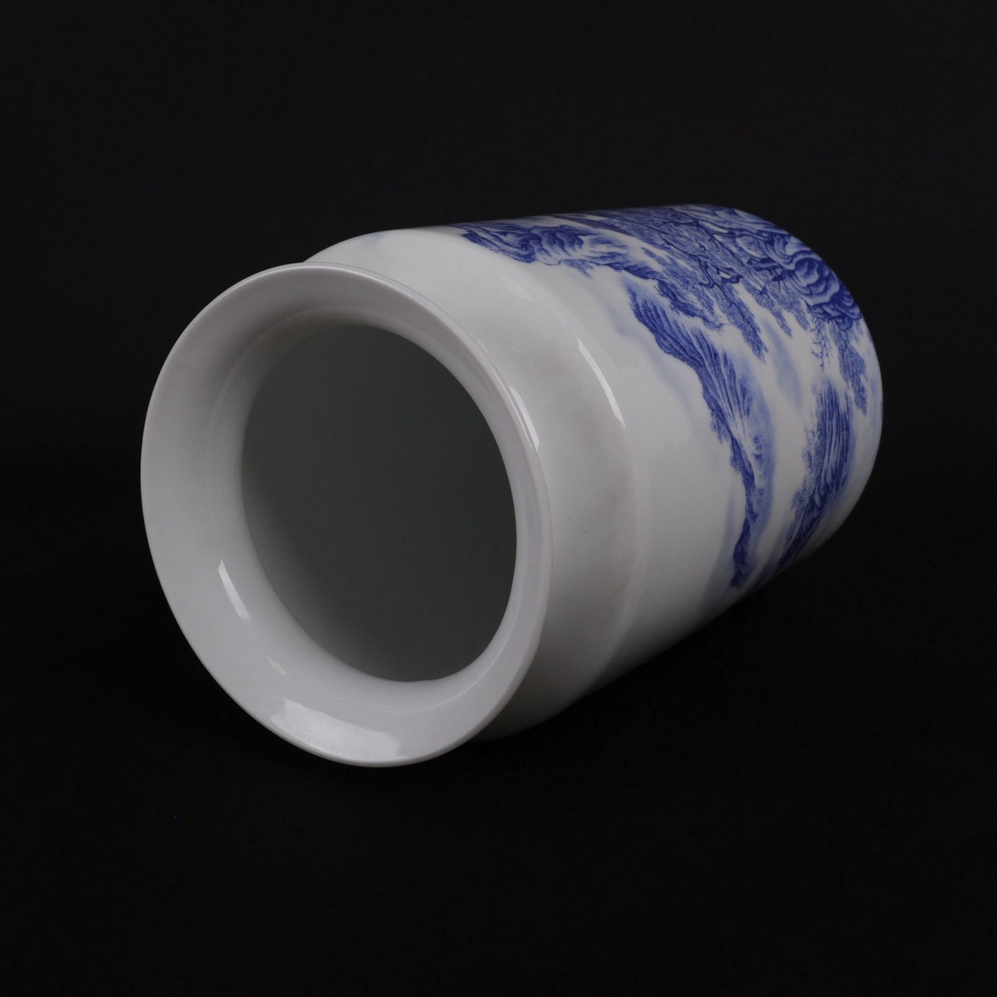 A pair of blue and white vases with mountain and water patterns