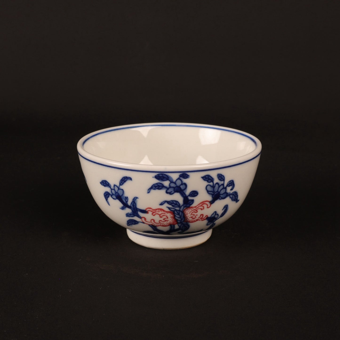 A pair of hand pressure cups with blue and white enamel, red blessings and longevity pictures