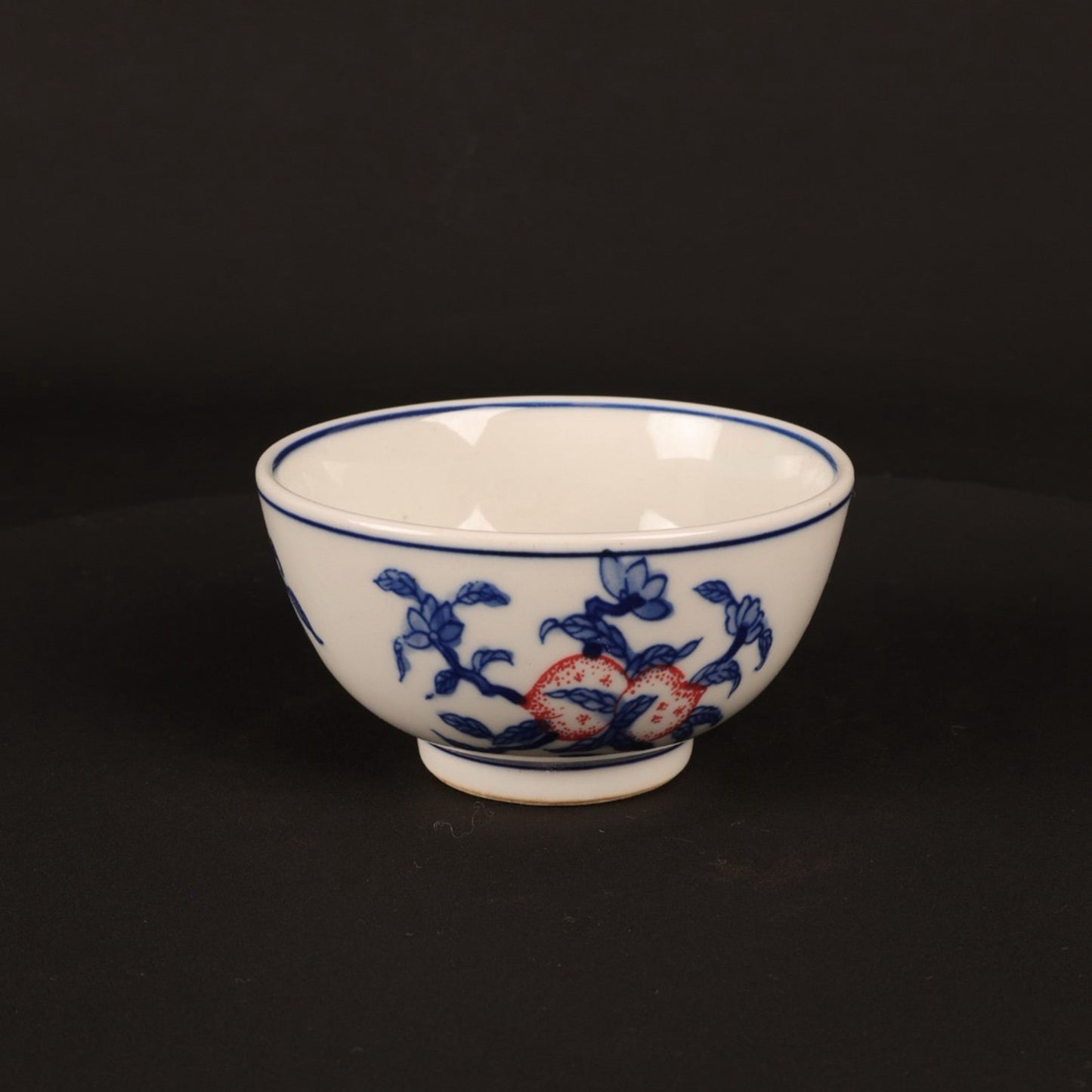 A pair of hand pressure cups with blue and white enamel, red blessings and longevity pictures