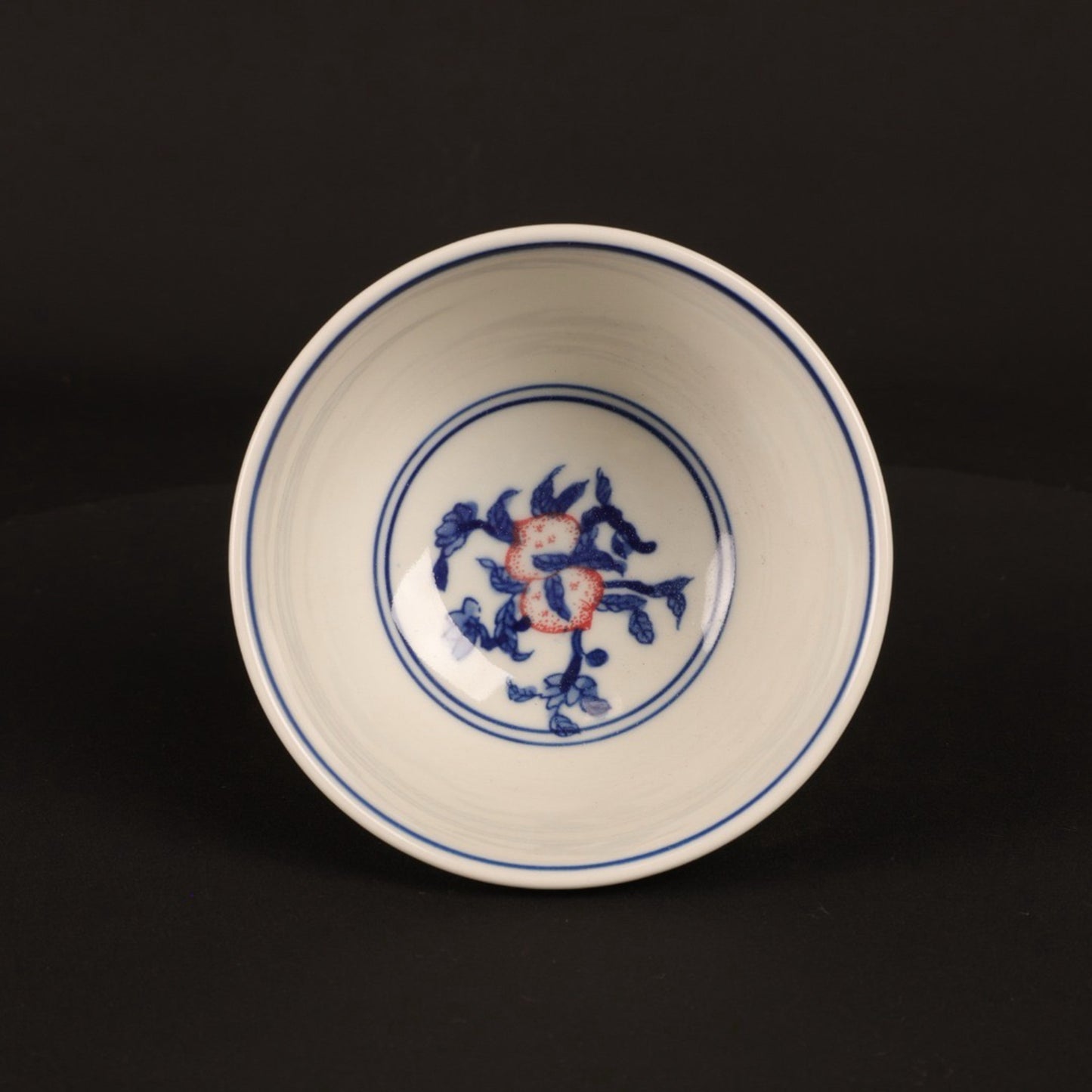 A pair of hand pressure cups with blue and white enamel, red blessings and longevity pictures