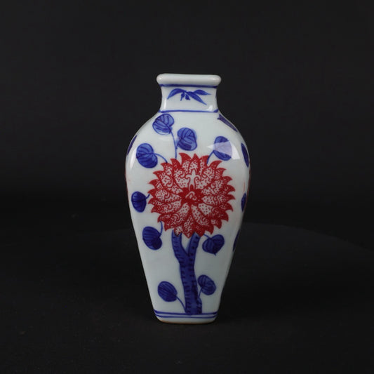 Blue and white glazed small vase with red floral patterns