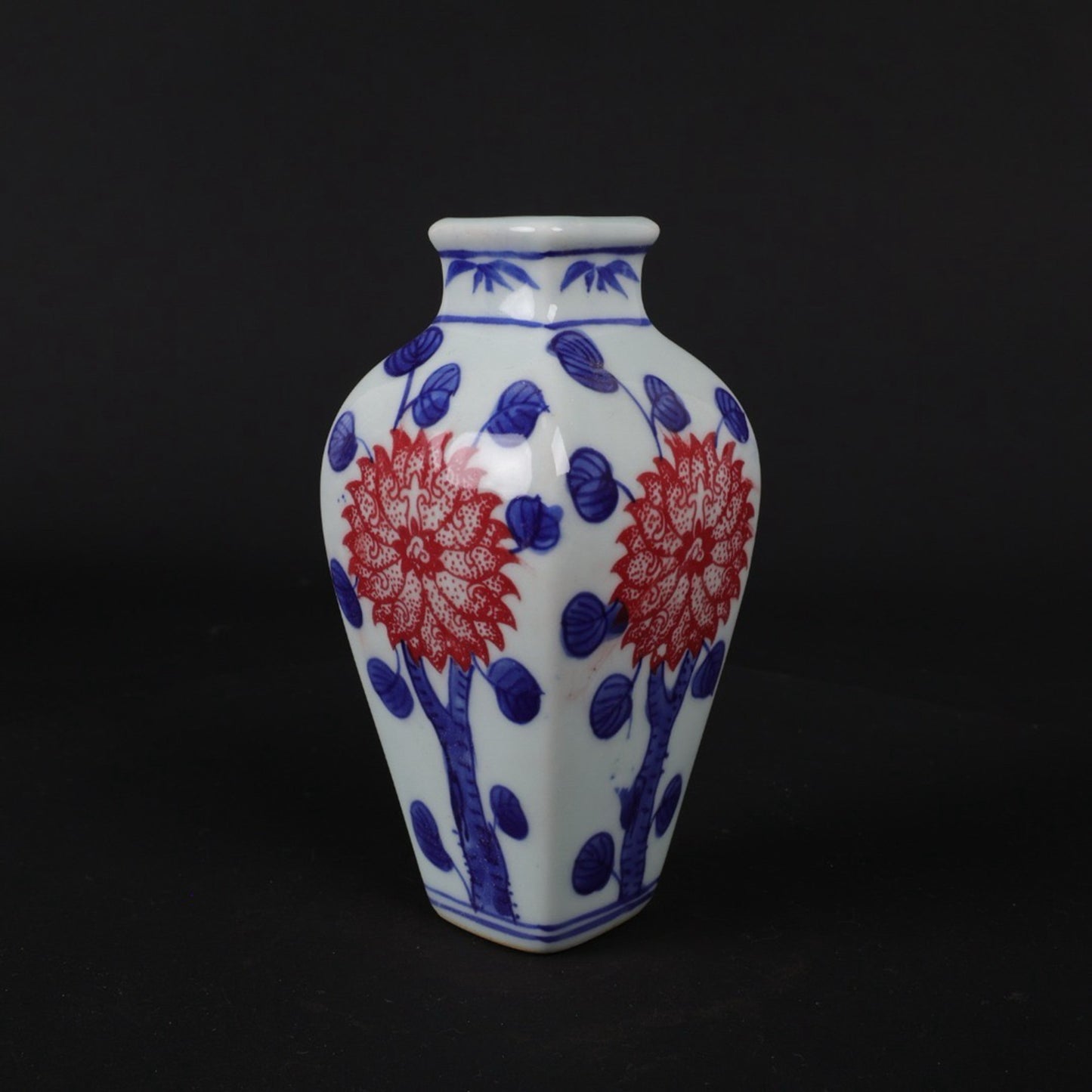 Blue and white glazed small vase with red floral patterns