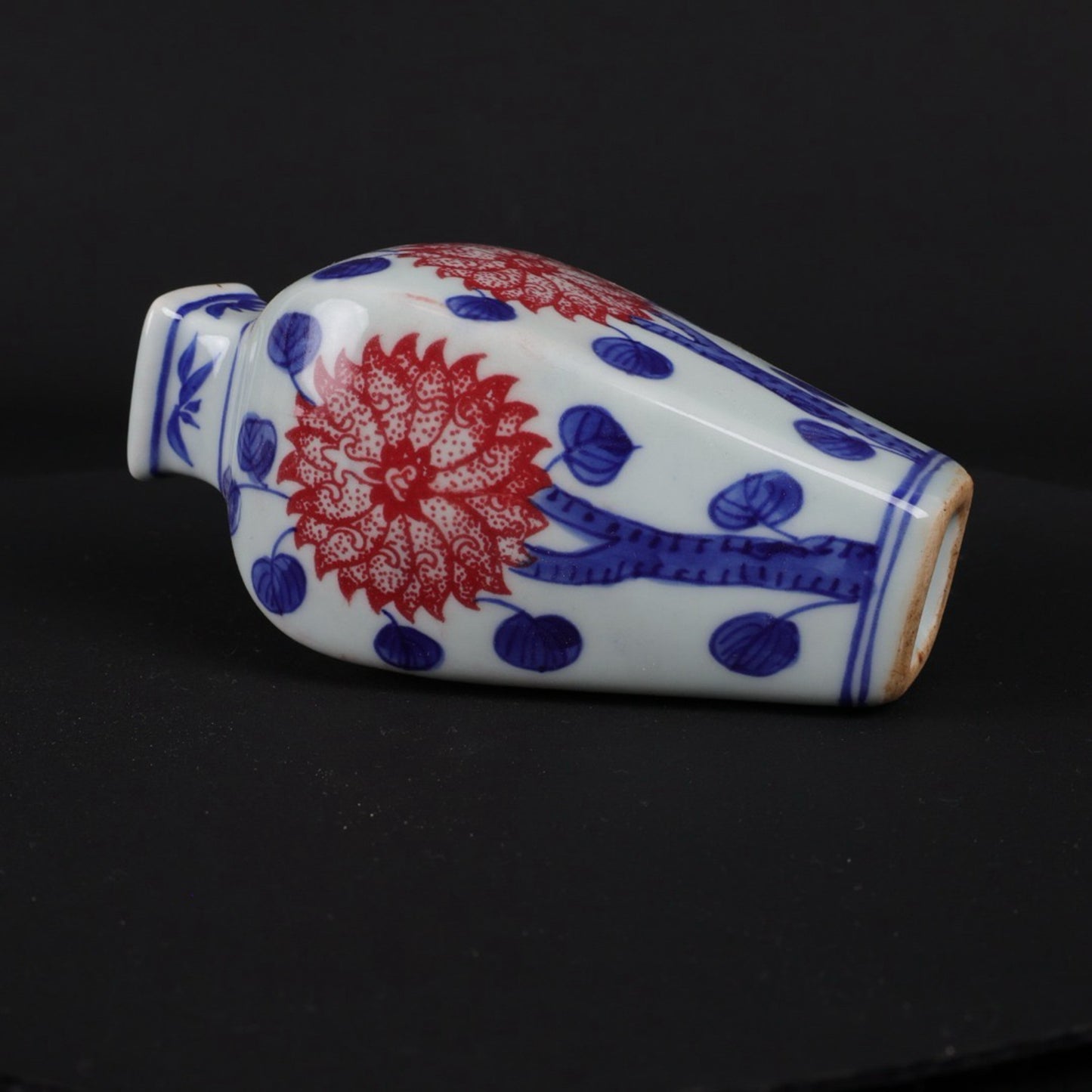Blue and white glazed small vase with red floral patterns