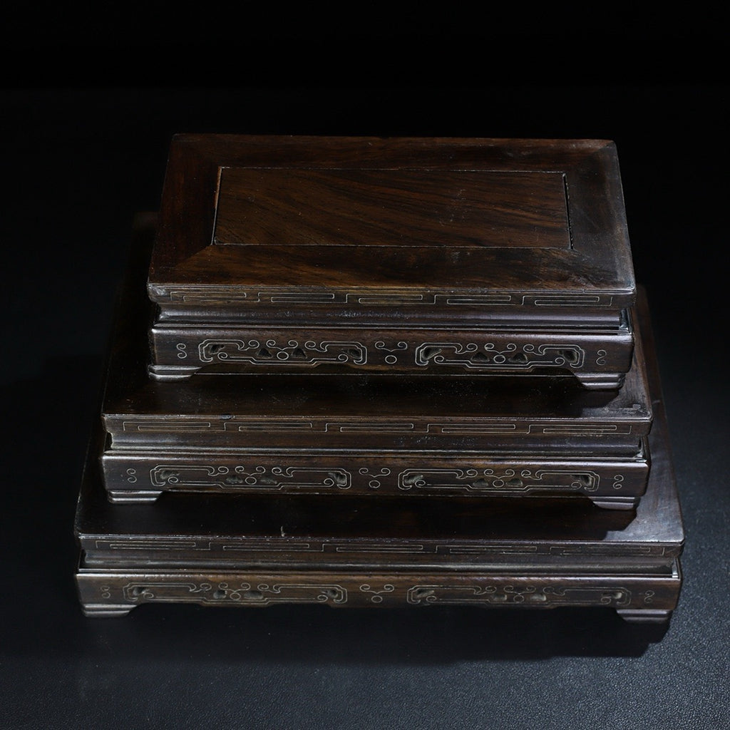 A set of rosewood silver wire rectangular base