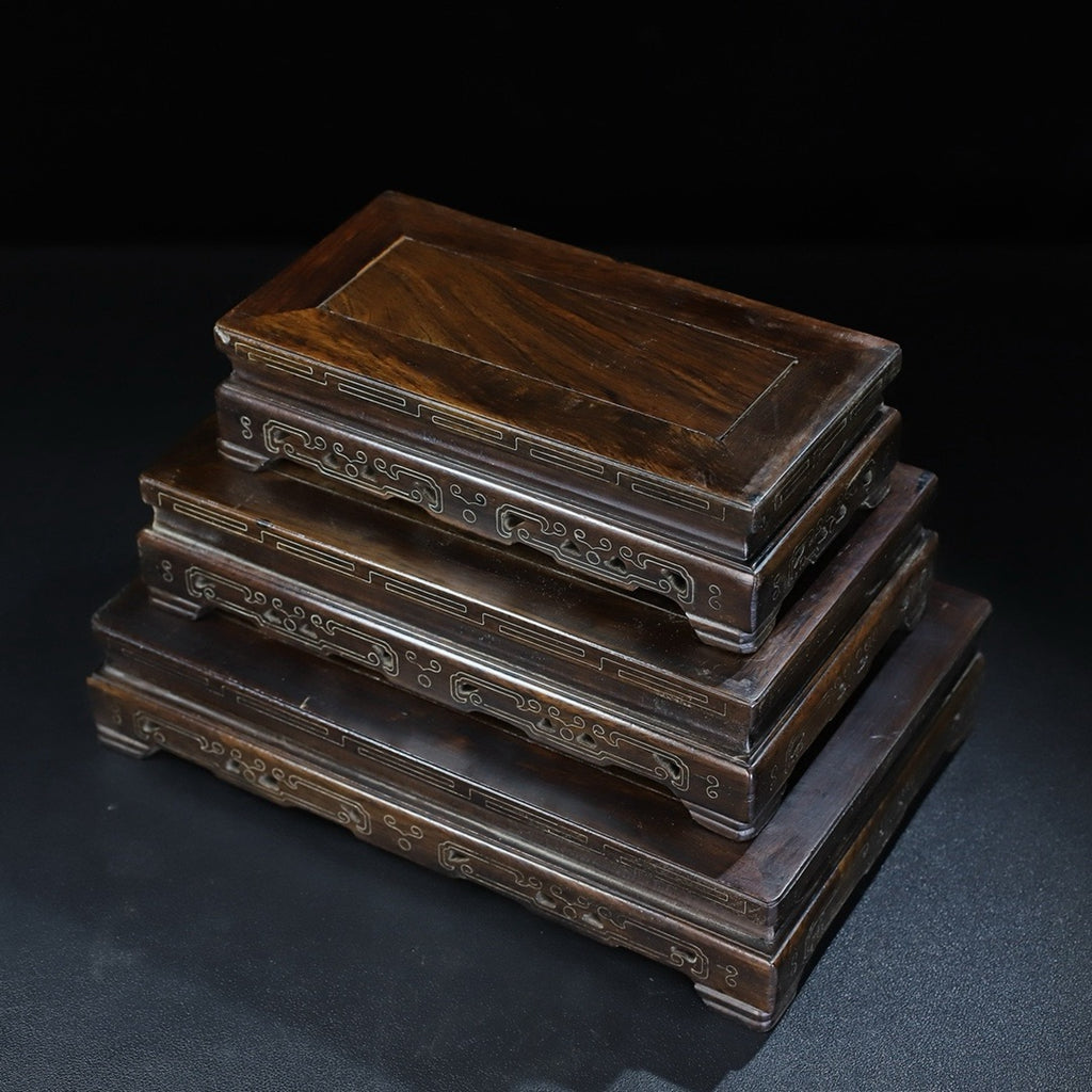 A set of rosewood silver wire rectangular base