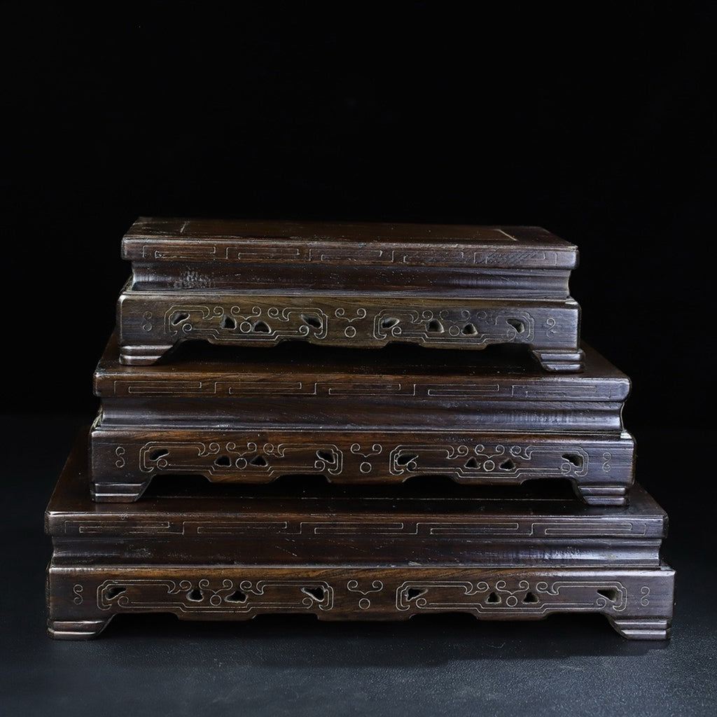 A set of rosewood silver wire rectangular base