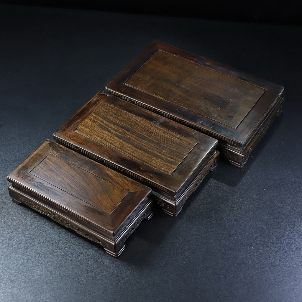A set of rosewood silver wire rectangular base