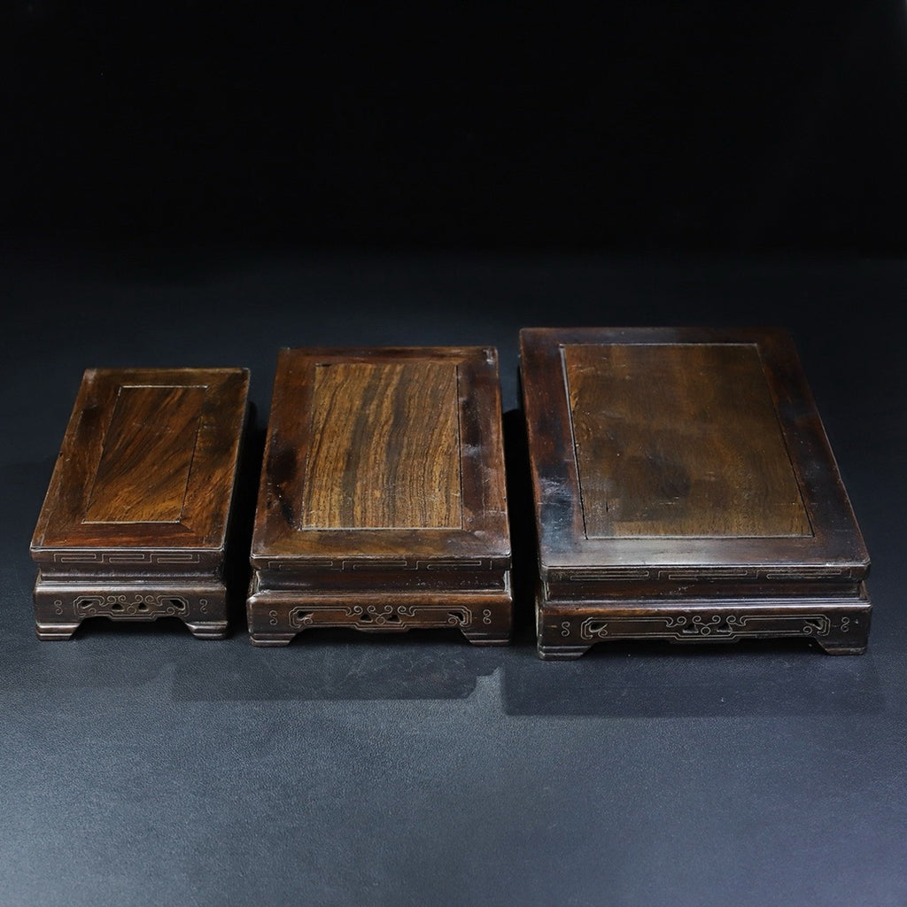 A set of rosewood silver wire rectangular base