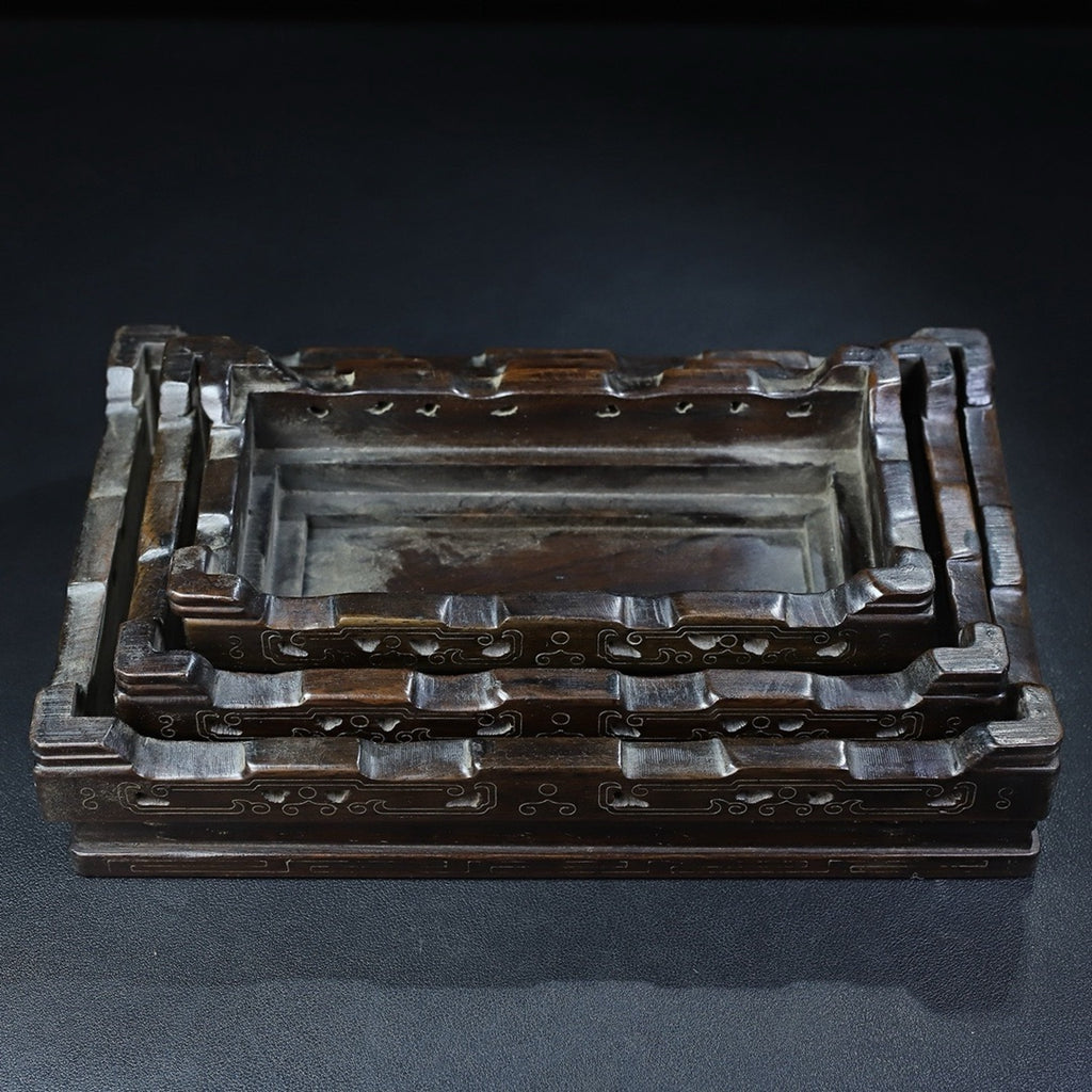 A set of rosewood silver wire rectangular base