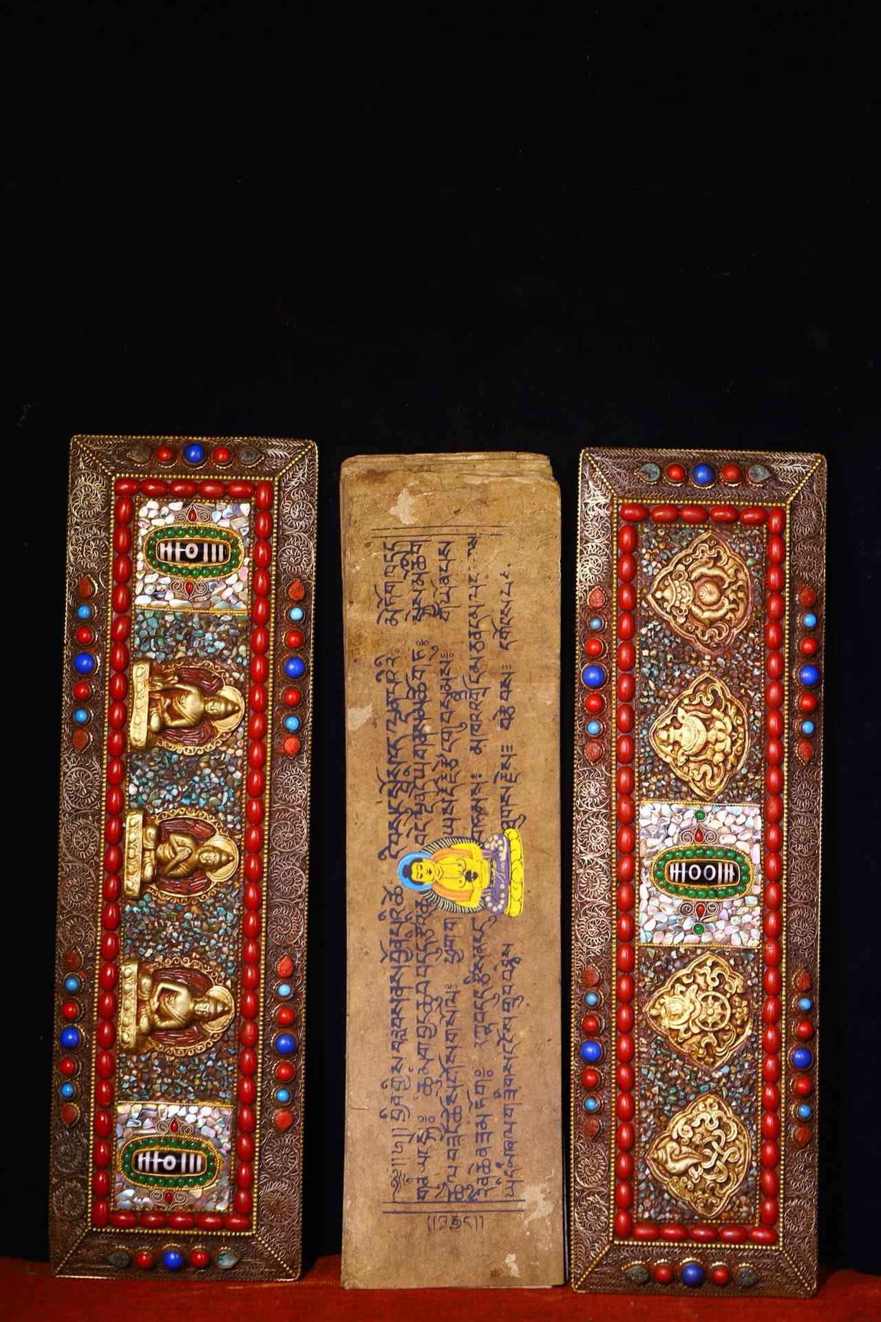Handmade tapping, chiseling, colorful inlay of gemstones, old scriptures