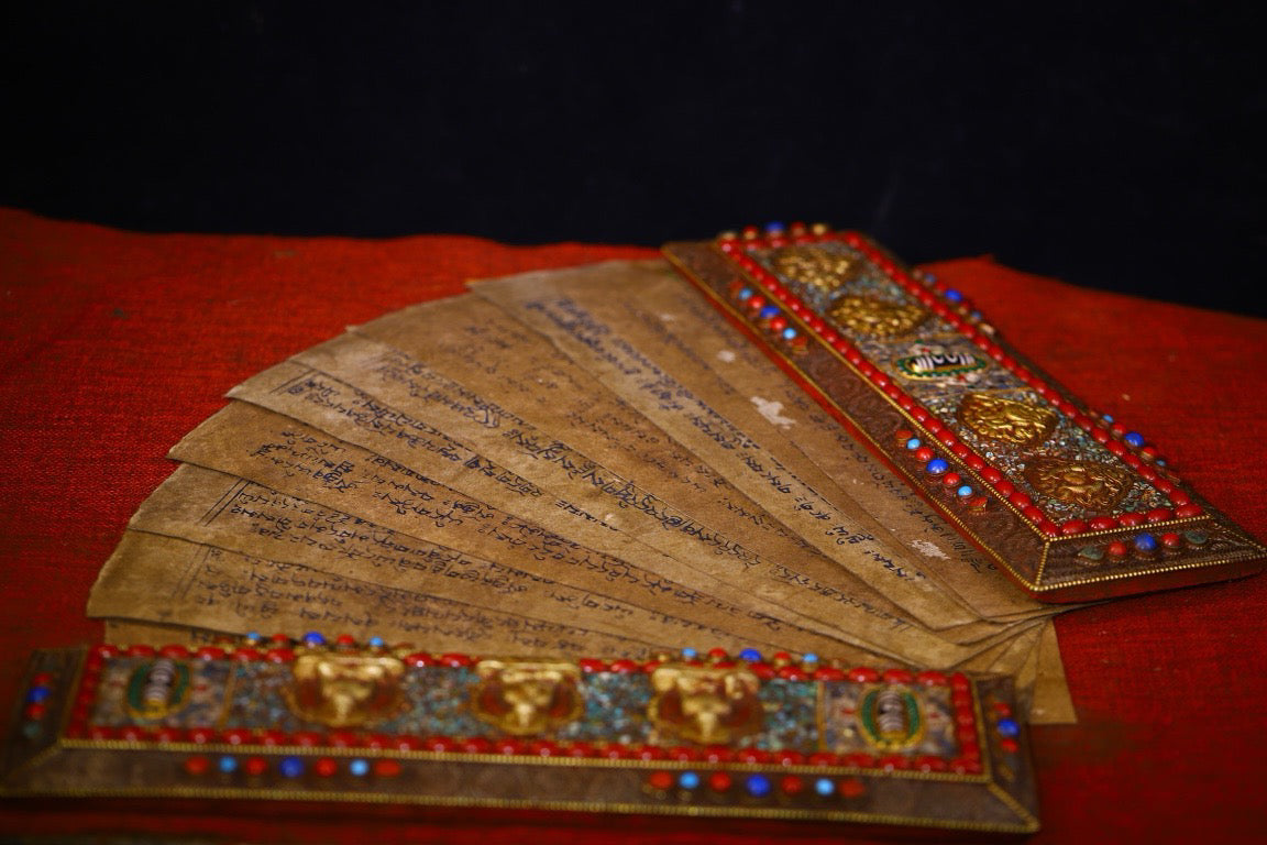 Handmade tapping, chiseling, colorful inlay of gemstones, old scriptures