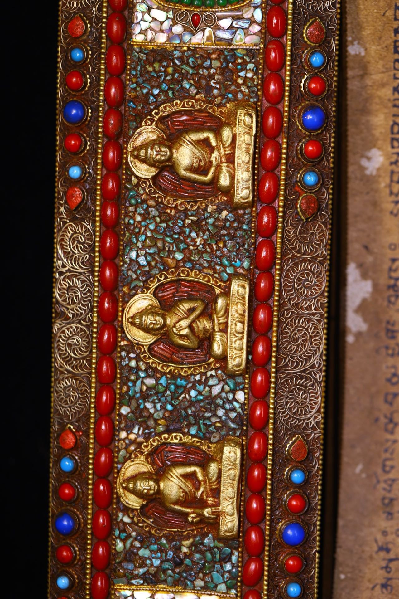 Handmade tapping, chiseling, colorful inlay of gemstones, old scriptures
