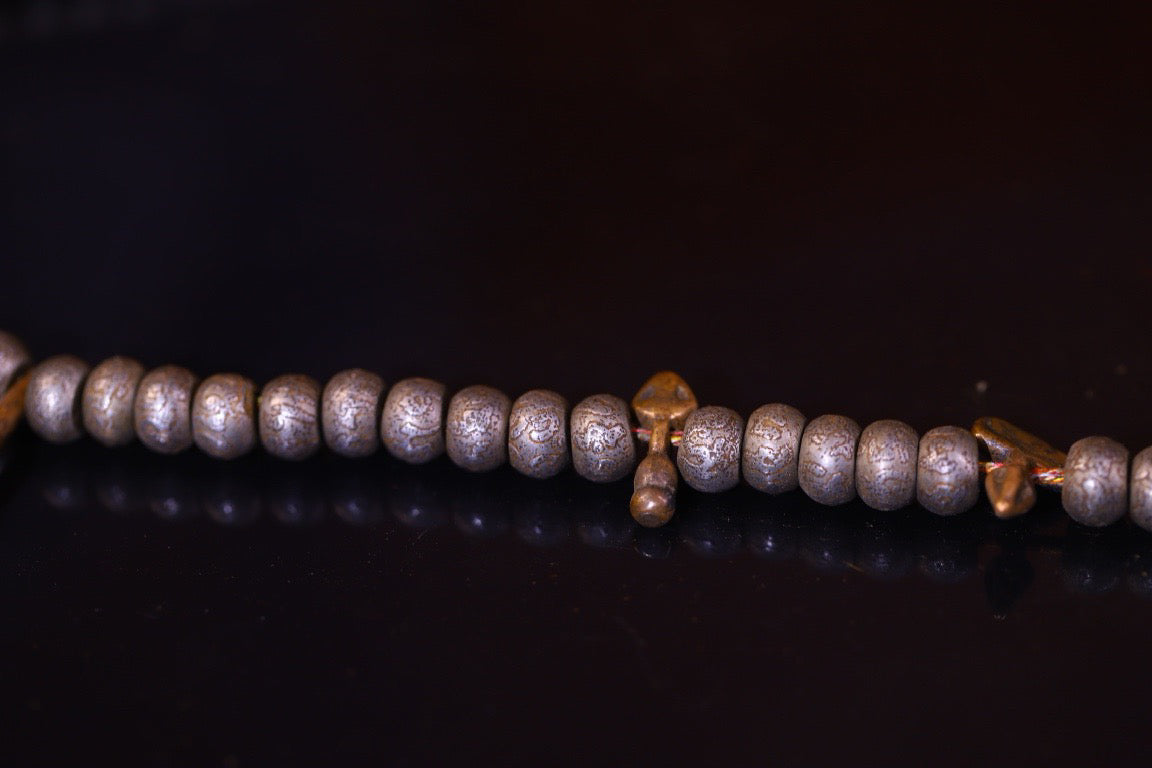 Tian Tie is purely handmade and has obvious signs of wear and tear on the carved Buddha beads