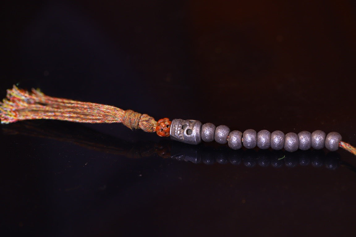 Tian Tie is purely handmade and has obvious signs of wear and tear on the carved Buddha beads