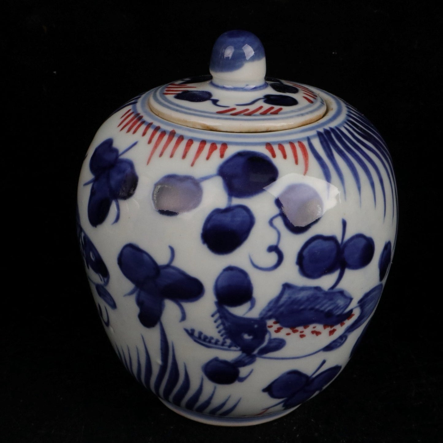 Blue and white glazed red fish and algae patterned small jar