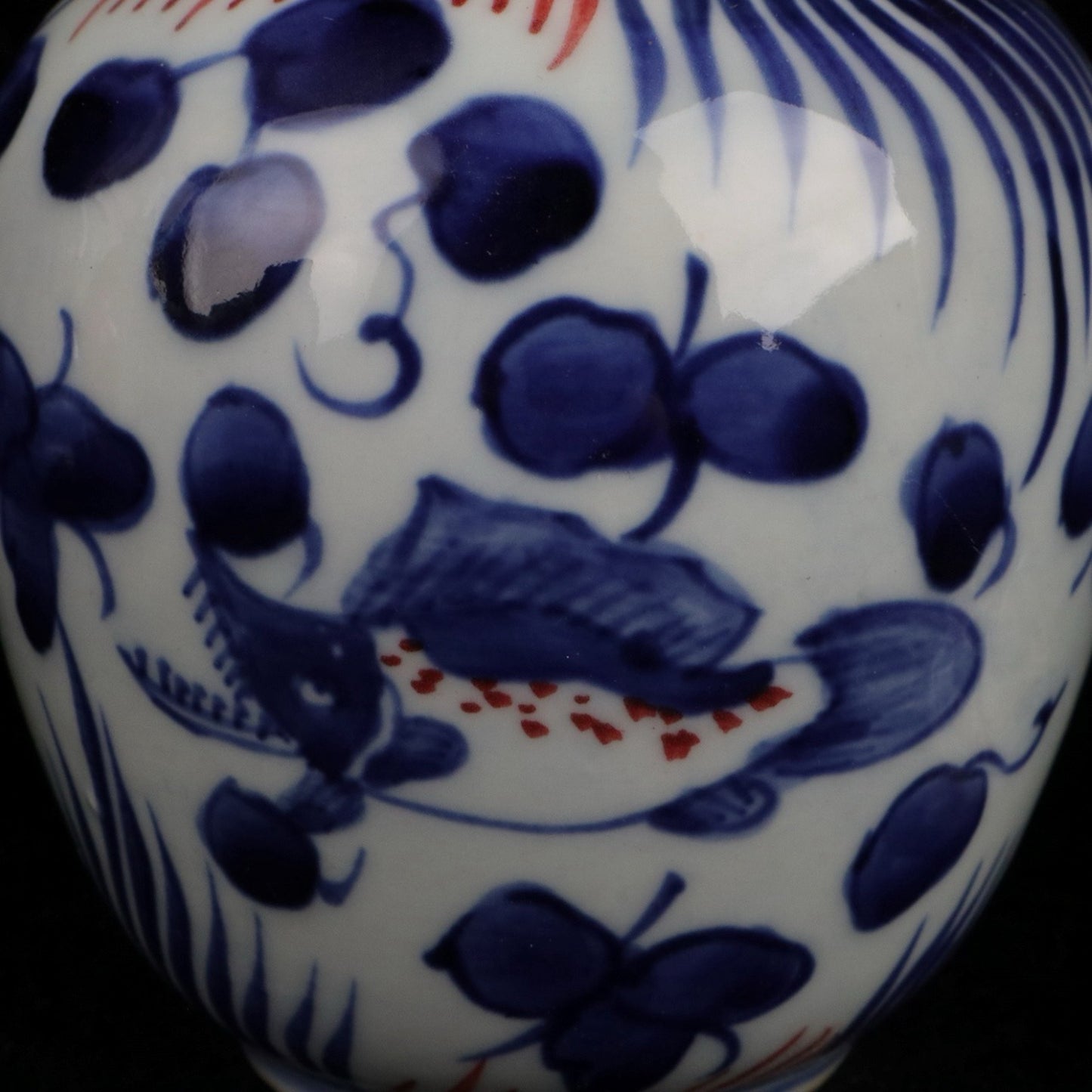 Blue and white glazed red fish and algae patterned small jar