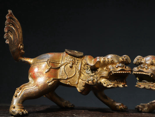 A pair of copper and gold [lion] ornaments