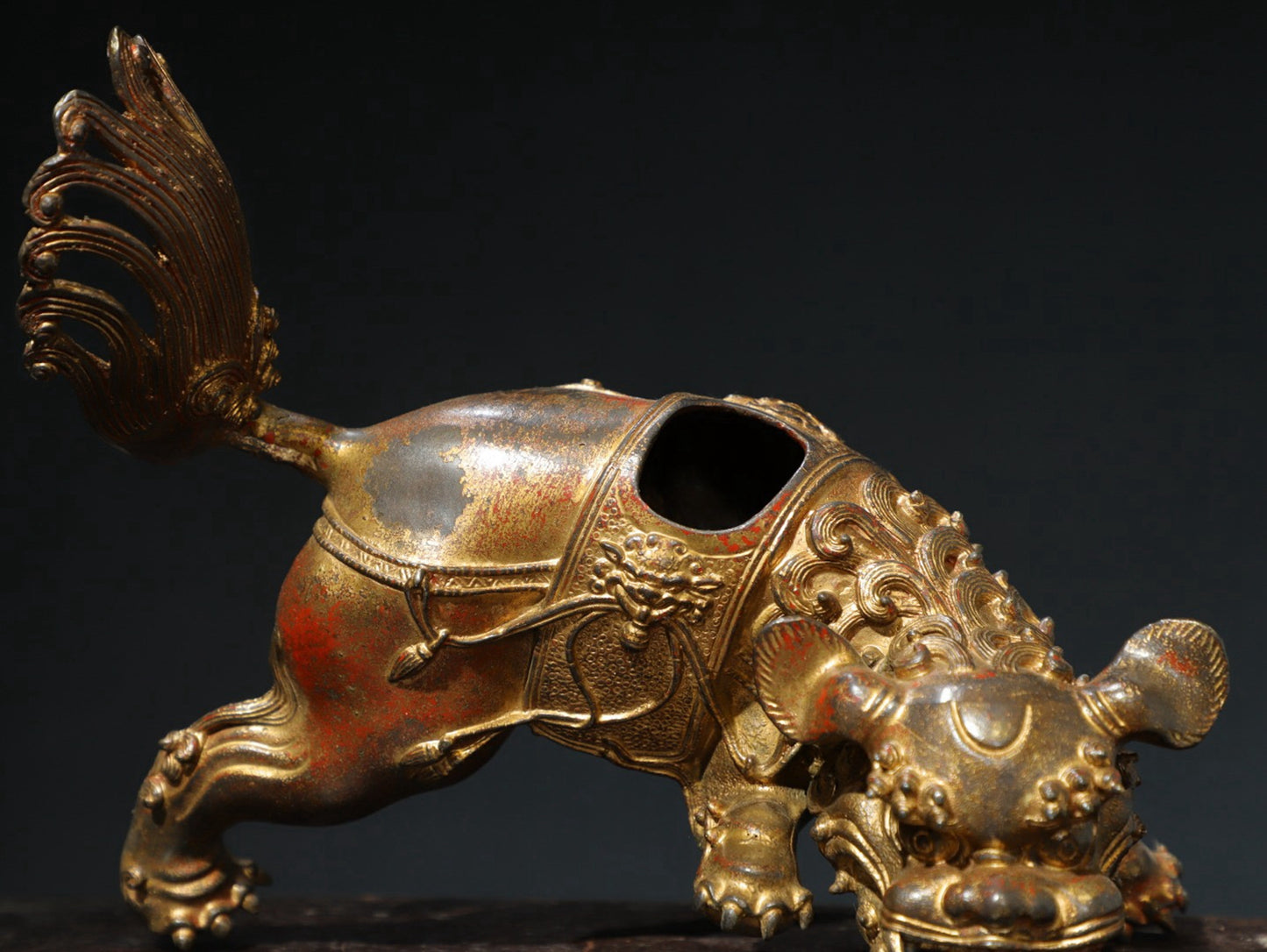 A pair of copper and gold [lion] ornaments