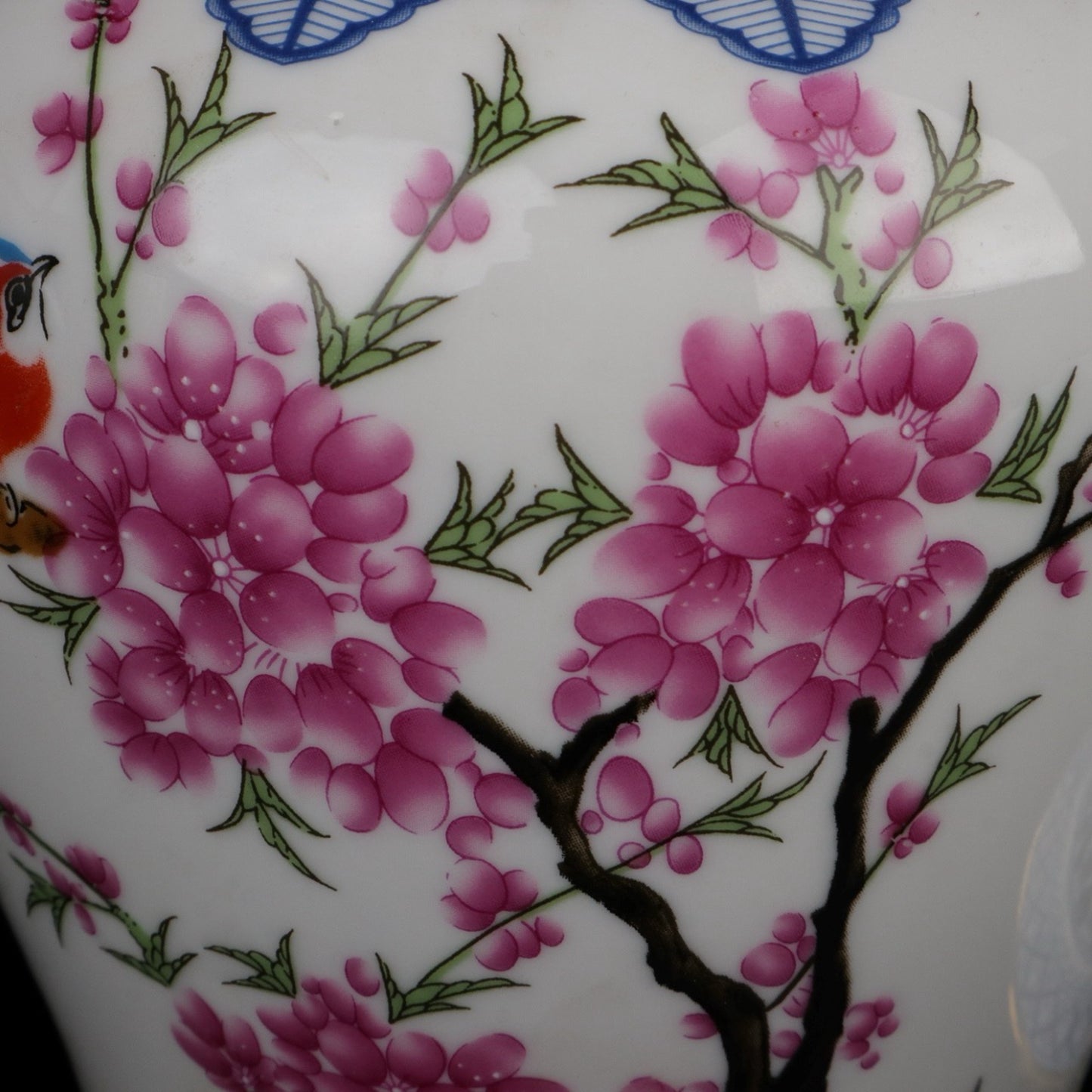 Blue and white jar with colorful bird songs and floral fragrance patterns