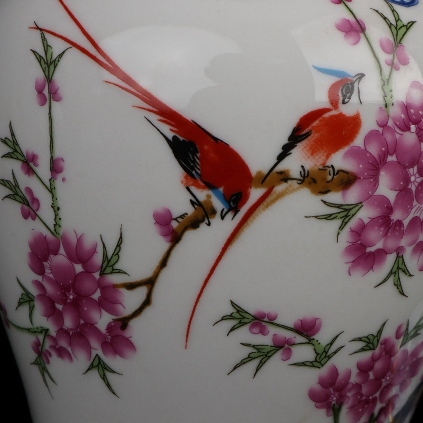 Blue and white jar with colorful bird songs and floral fragrance patterns