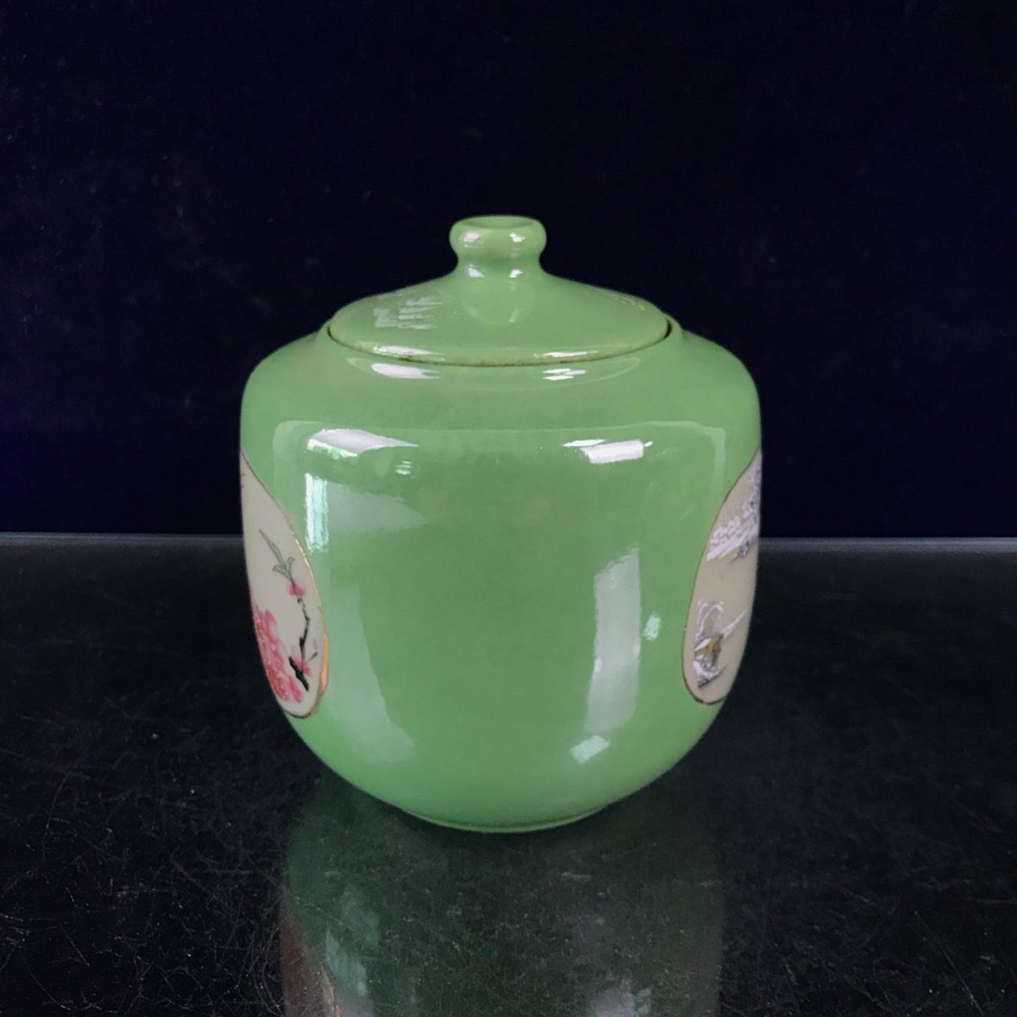 Green glazed open window jar with flower and bird pattern lid