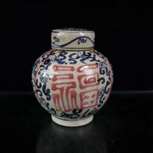 Open-piece blue and white glazed jar with a red blessing pattern lid