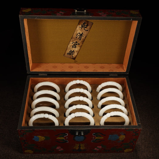 A box of Chinese antique dragon head white jade bracelets