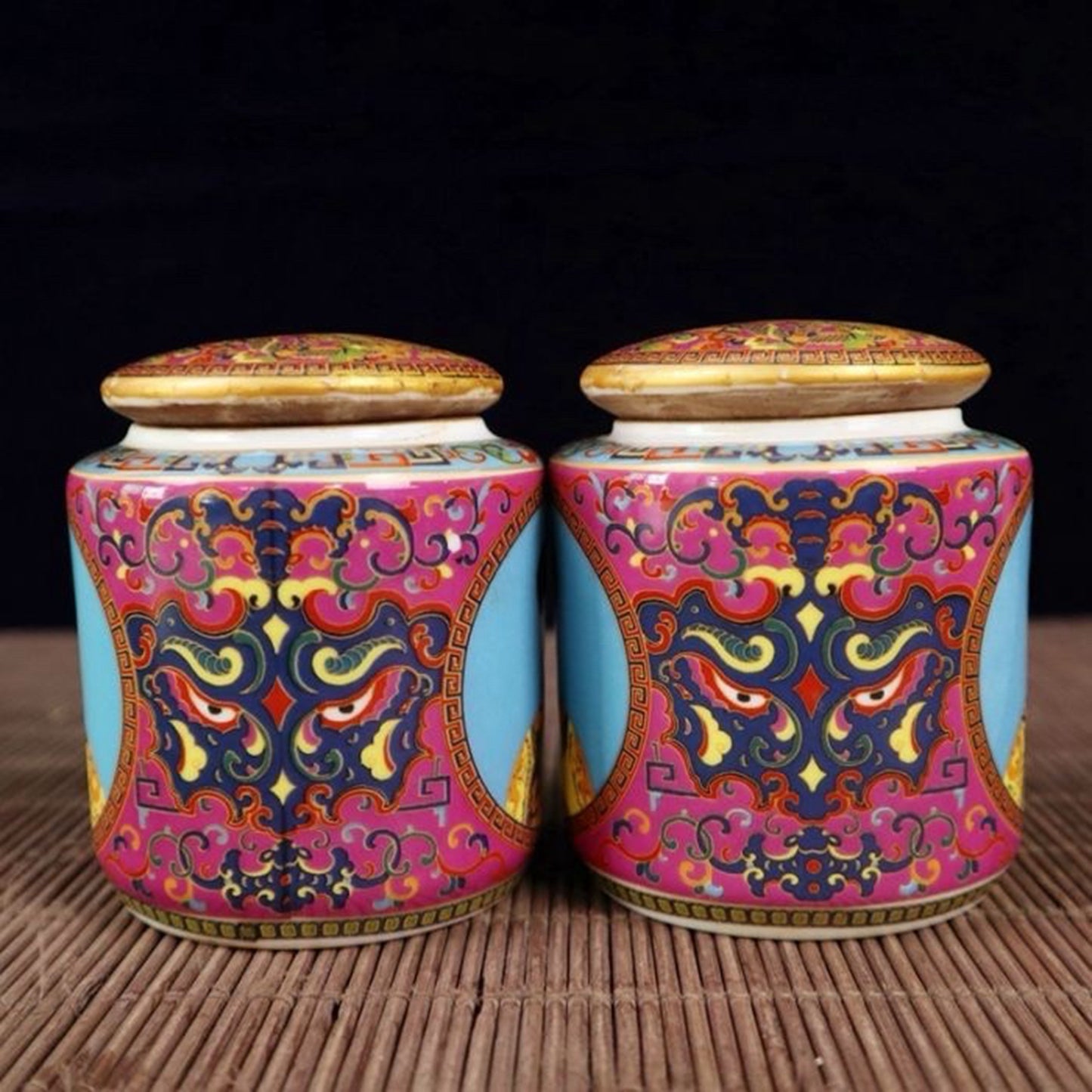 A pair of enamel colored figure patterned lid jars