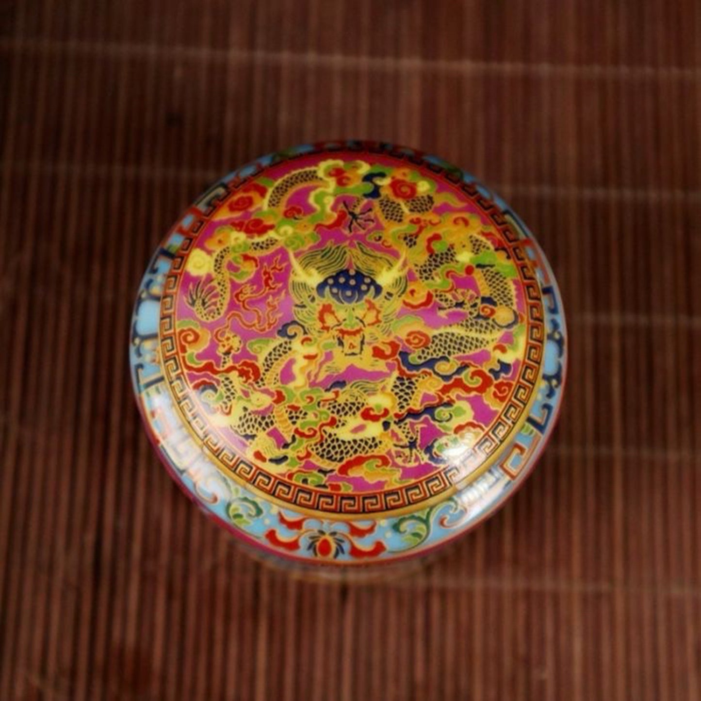 A pair of enamel colored figure patterned lid jars