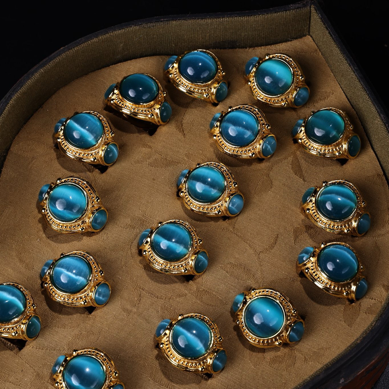 A box of Chinese antique green blue eye stone rings