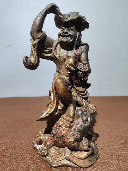 Buddha statue with old copper body, mud and gold, blooming and scattering cinnabar