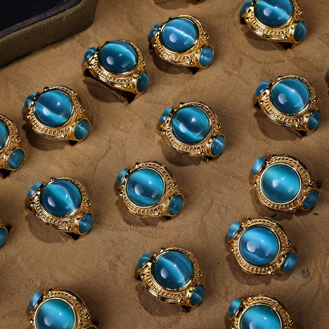 A box of Chinese antique green blue eye stone rings