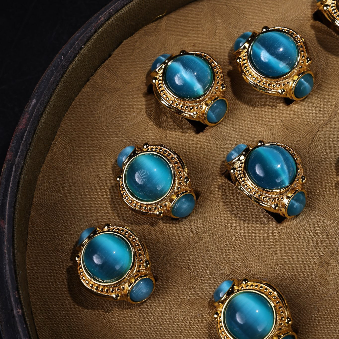 A box of Chinese antique green blue eye stone rings