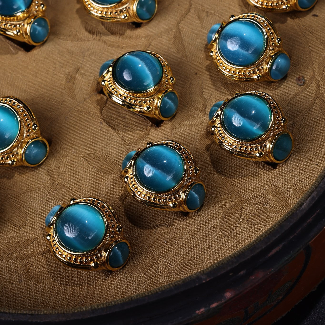 A box of Chinese antique green blue eye stone rings