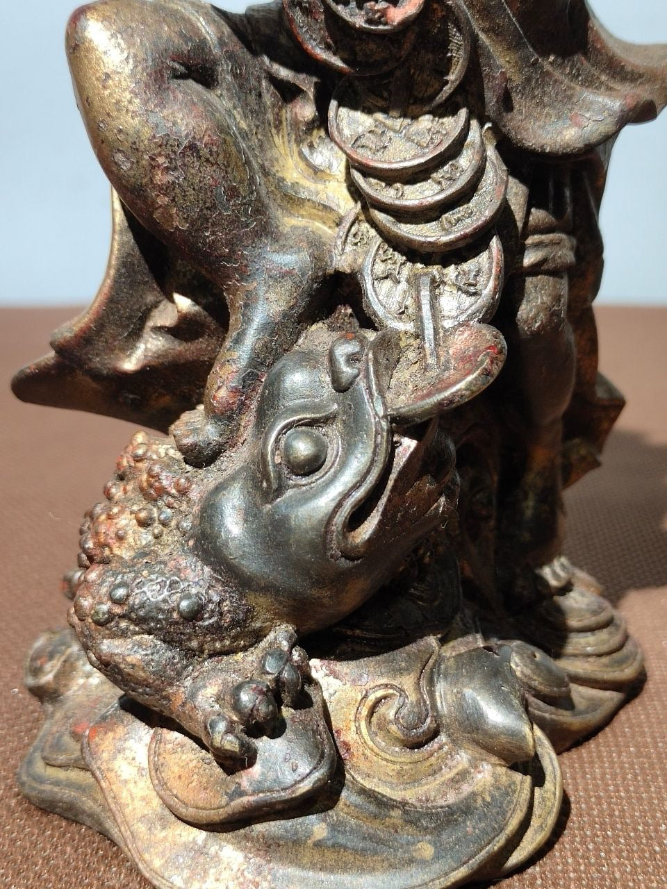 Buddha statue with old copper body, mud and gold, blooming and scattering cinnabar