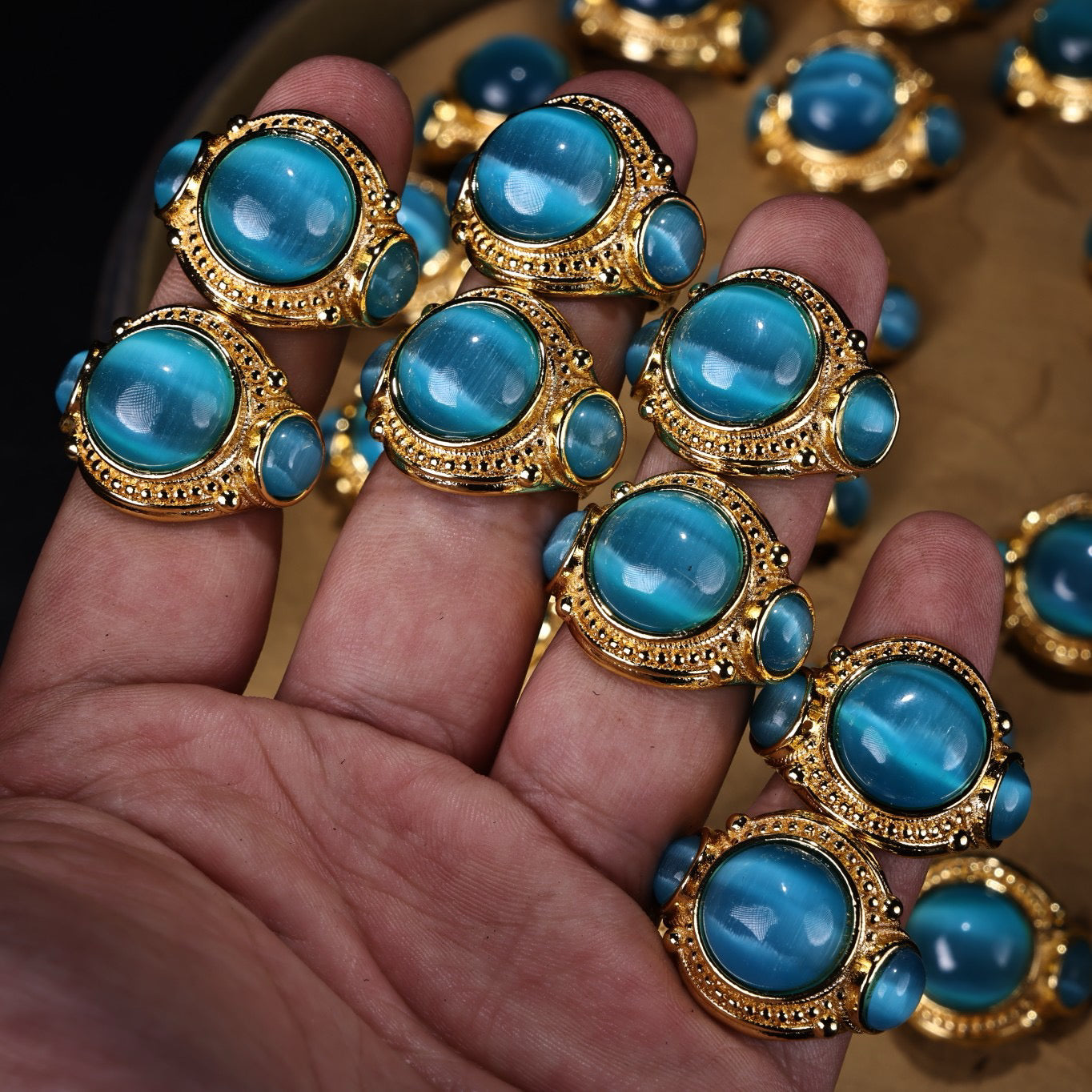 A box of Chinese antique green blue eye stone rings