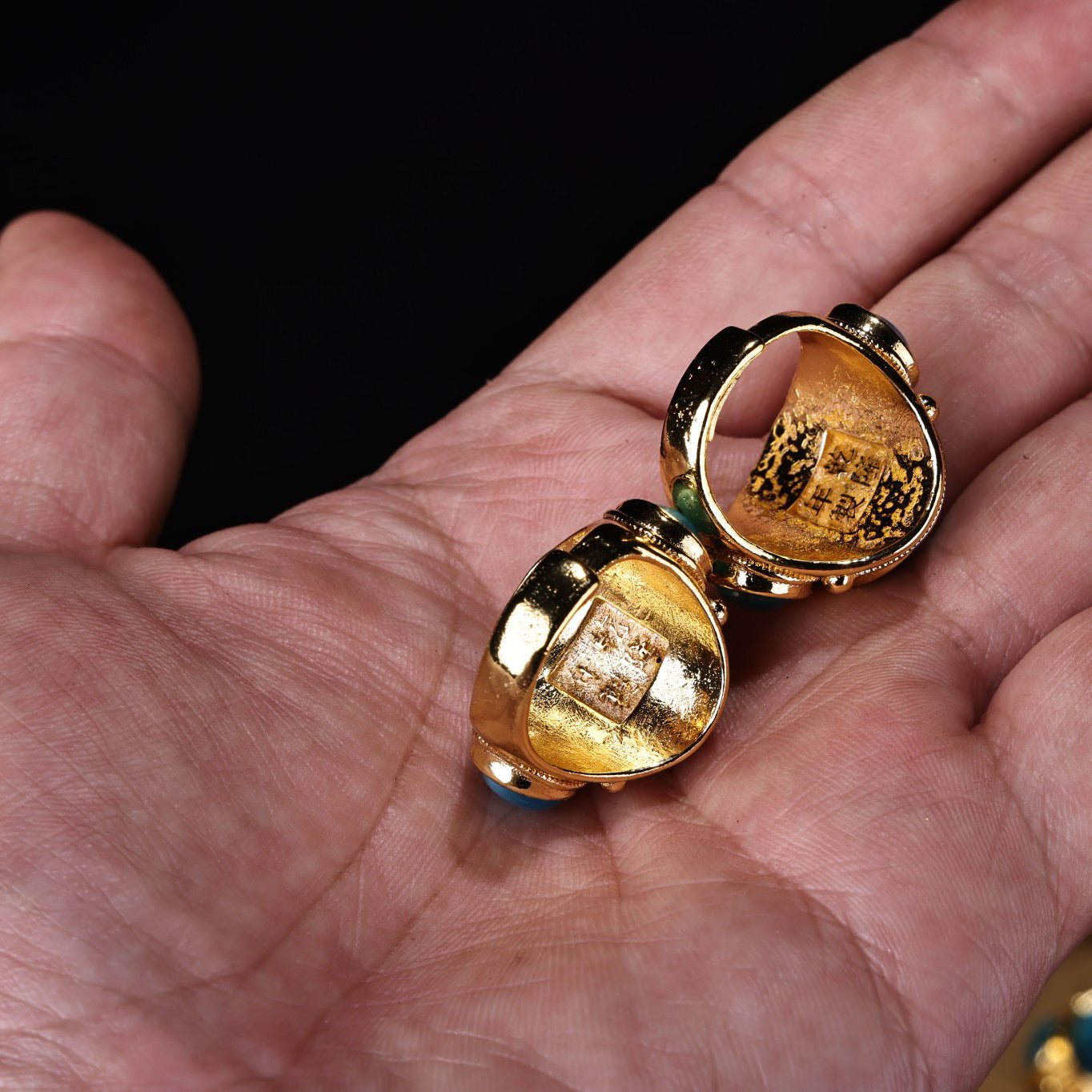 A box of Chinese antique green blue eye stone rings