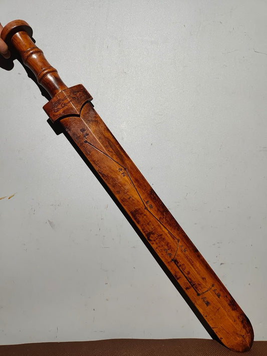 A solid wood carved sword