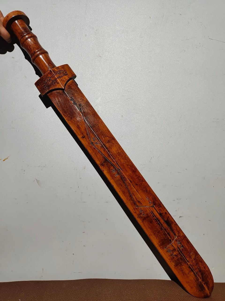 A solid wood carved sword