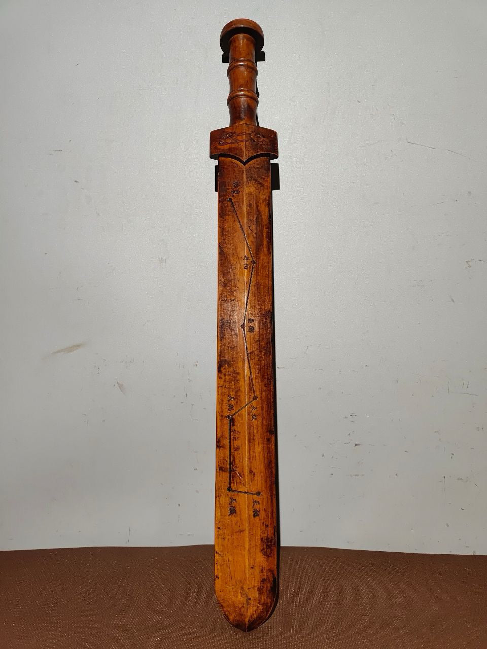 A solid wood carved sword